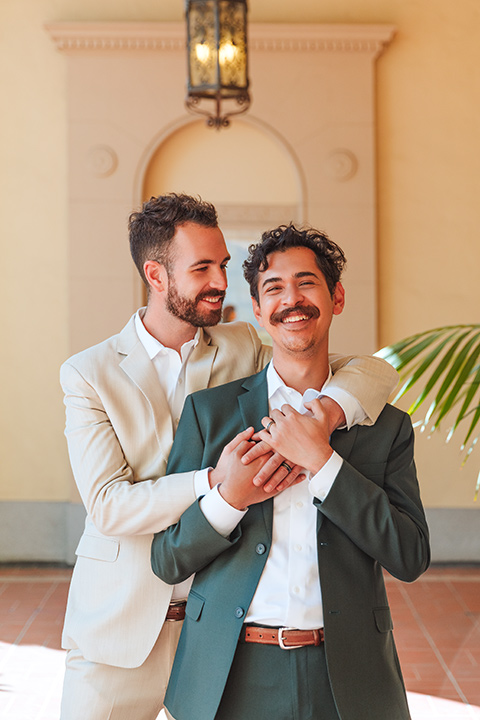  engagement shoot in long beach CA with one groom in a tan suit and the other groom in a green suit