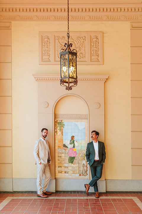  engagement shoot in long beach CA with one groom in a tan suit and the other groom in a green suit 