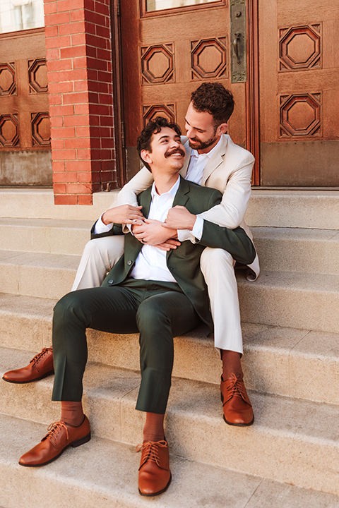  engagement shoot in long beach CA with one groom in a tan suit and the other groom in a green suit 