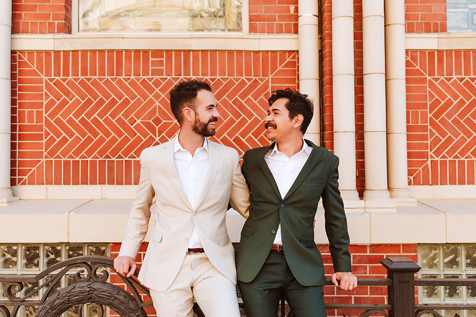  engagement shoot in long beach CA with one groom in a tan suit and the other groom in a green suit