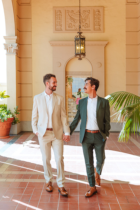  engagement shoot in long beach CA with one groom in a tan suit and the other groom in a green suit 