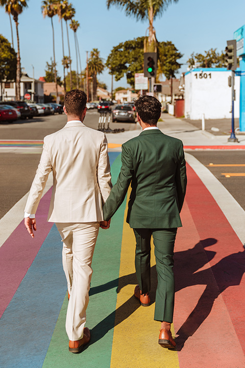  engagement shoot in long beach CA with one groom in a tan suit and the other groom in a green suit 