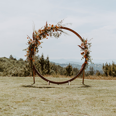  wedding ceremony arch with dried flowers on a wood or copper base