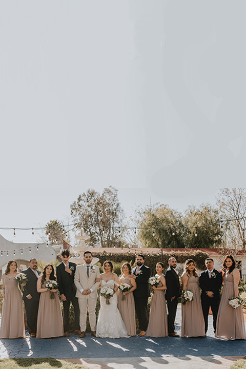  bridal parties that have neutral colors to them, such as the first wedding with a taupe and navy color scheme and the second wedding with a black, tan, and gold wedding color scheme