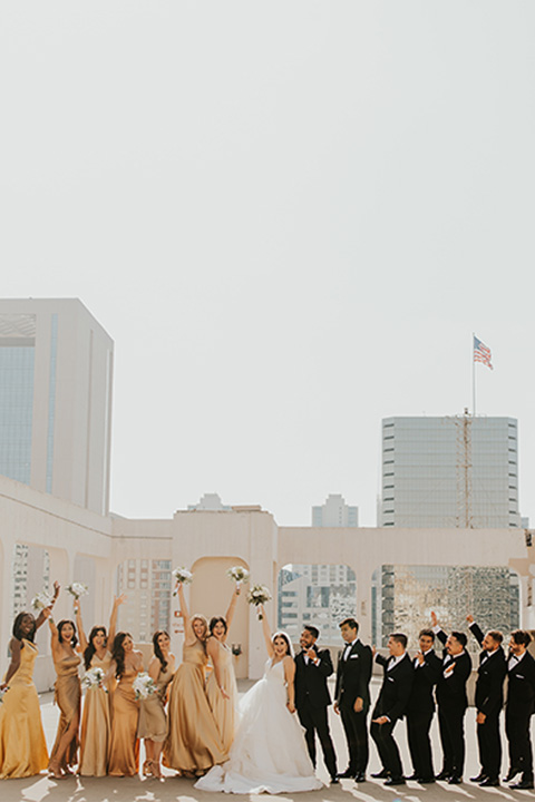  bridal parties that have neutral colors to them, such as the first wedding with a taupe and navy color scheme and the second wedding with a black, tan, and gold wedding color scheme 