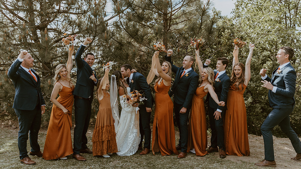  a bridal party with navy and burnt orange color scheme and style  