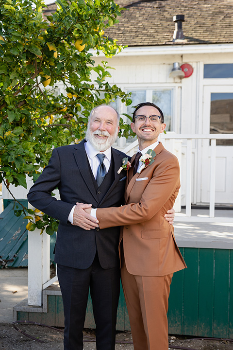  father of the bride in a steel blue suit with a sage green tie 
