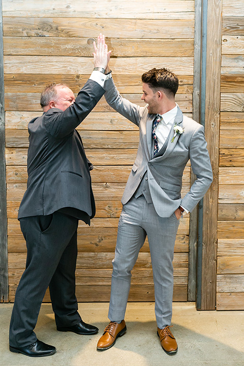 father of the bride in a light grey suit 