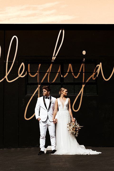  alleylujah neutral wedding – bride in a modern white gown and the groom in a white shawl lapel tuxedo