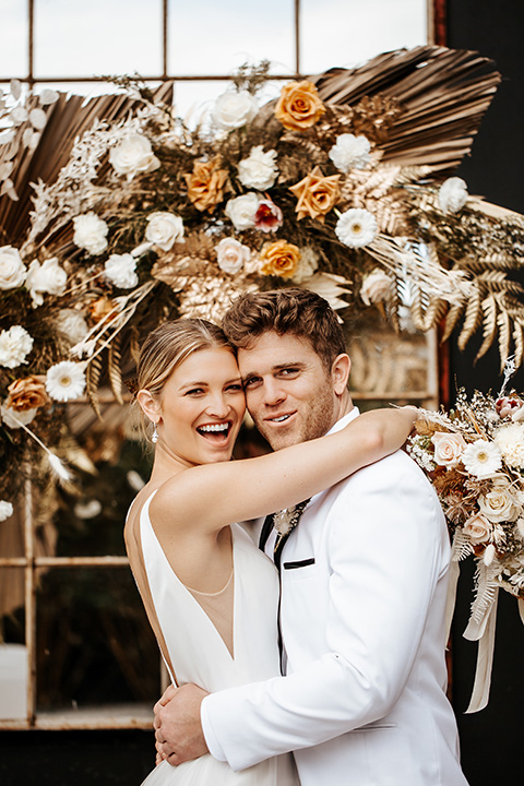  alleylujah neutral wedding – bride in a modern white gown and the groom in a white shawl lapel tuxedo 