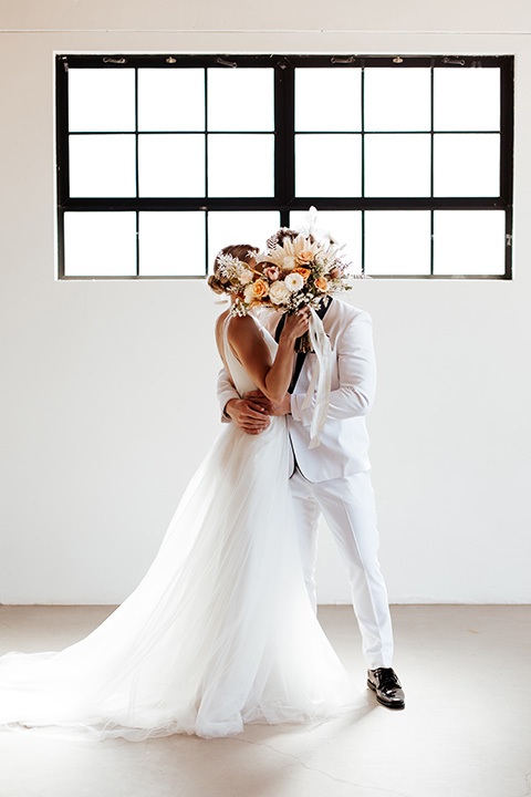  alleylujah neutral wedding – bride in a modern white gown and the groom in a white shawl lapel tuxedo