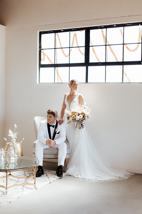  alleylujah neutral wedding – bride in a modern white gown and the groom in a white shawl lapel tuxedo 