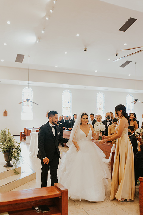  industrial wedding at the pannikin building in san diego with gold bridesmaids gowns and black tuxedos for the groom and groomsmen 