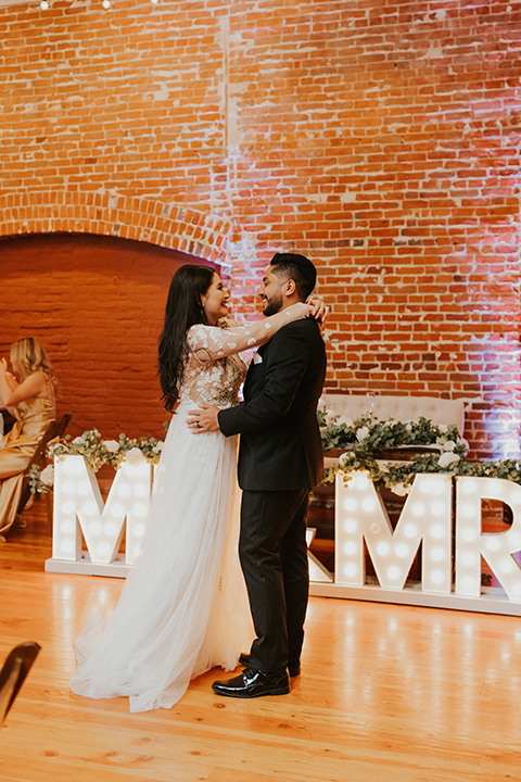  industrial wedding at the pannikin building in san diego with gold bridesmaids gowns and black tuxedos for the groom and groomsmen 