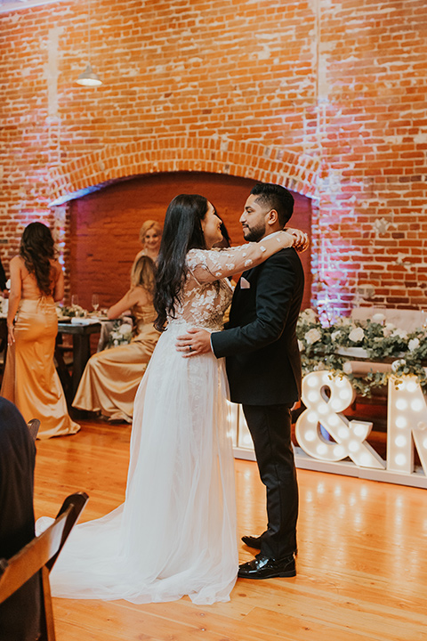  industrial wedding at the pannikin building in san diego with gold bridesmaids gowns and black tuxedos for the groom and groomsmen 