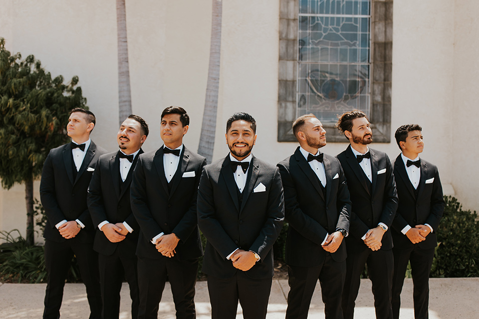  industrial wedding at the pannikin building in san diego with gold bridesmaids gowns and black tuxedos for the groom and groomsmen 