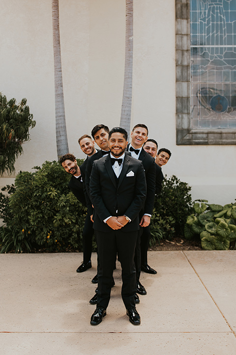  industrial wedding at the pannikin building in san diego with gold bridesmaids gowns and black tuxedos for the groom and groomsmen 