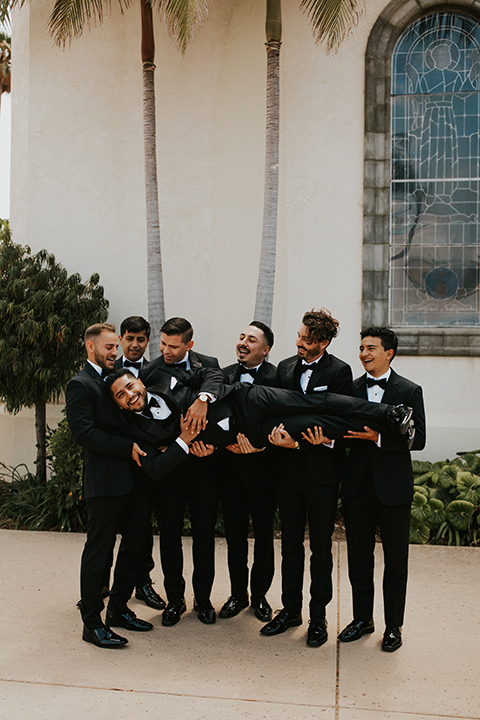  industrial wedding at the pannikin building in san diego with gold bridesmaids gowns and black tuxedos for the groom and groomsmen 