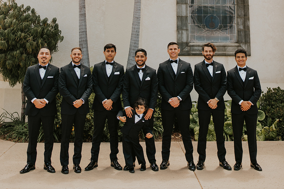  industrial wedding at the pannikin building in san diego with gold bridesmaids gowns and black tuxedos for the groom and groomsmen 