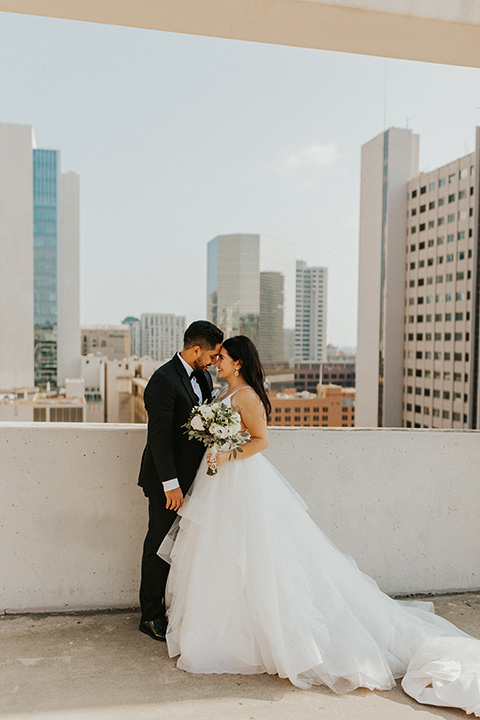  industrial wedding at the pannikin building in san diego with gold bridesmaids gowns and black tuxedos for the groom and groomsmen 