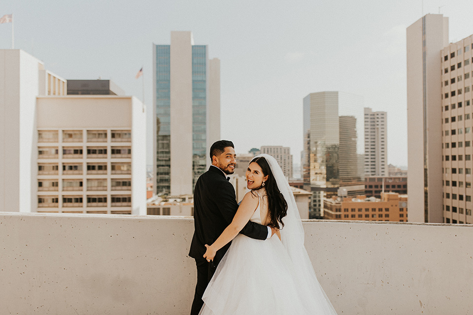  industrial wedding at the pannikin building in san diego with gold bridesmaids gowns and black tuxedos for the groom and groomsmen 