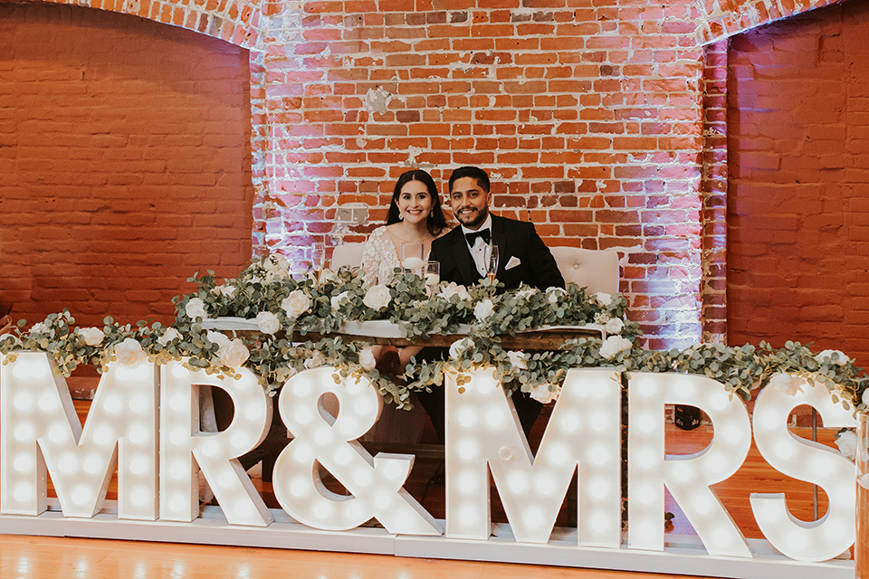  industrial wedding at the pannikin building in san diego with gold bridesmaids gowns and black tuxedos for the groom and groomsmen 