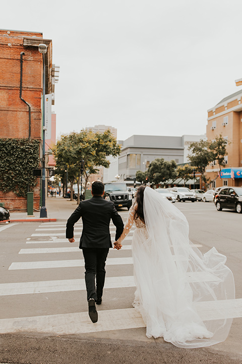  industrial wedding at the pannikin building in san diego with gold bridesmaids gowns and black tuxedos for the groom and groomsmen 