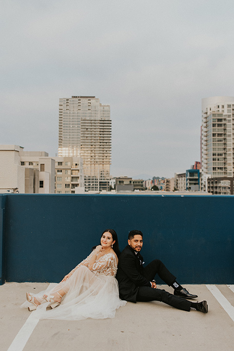  industrial wedding at the pannikin building in san diego with gold bridesmaids gowns and black tuxedos for the groom and groomsmen 