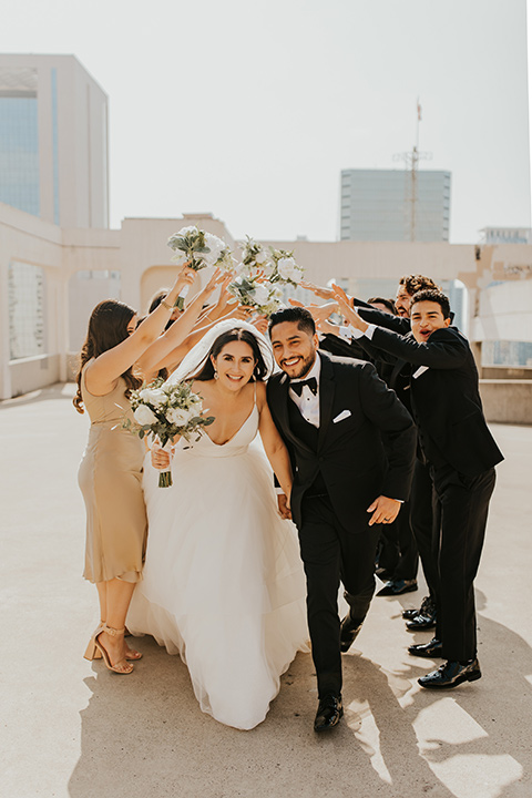  industrial wedding at the pannikin building in san diego with gold bridesmaids gowns and black tuxedos for the groom and groomsmen 