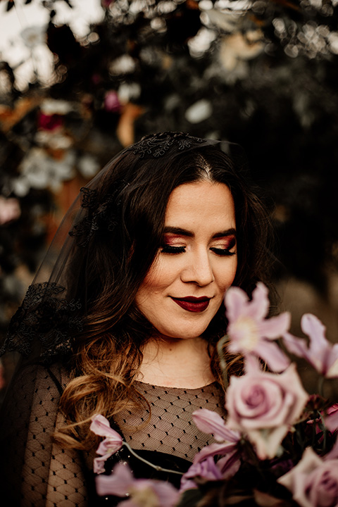  bride in a black bridal gown with a pin dot overlay 