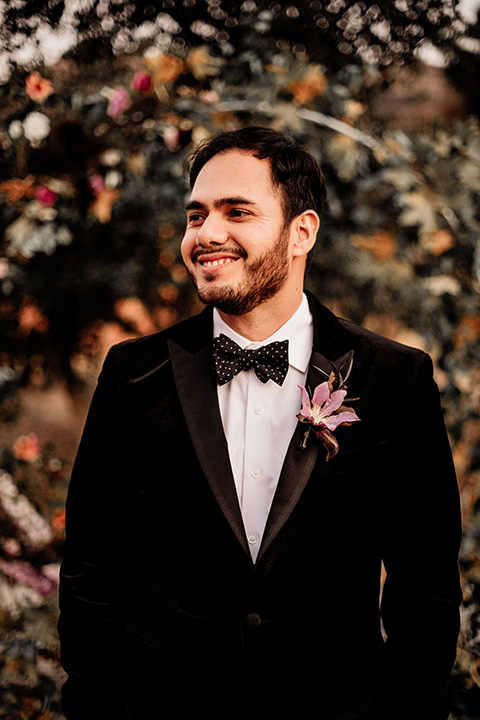  halloween inspired wedding with the groom in black velvet tuxedo 