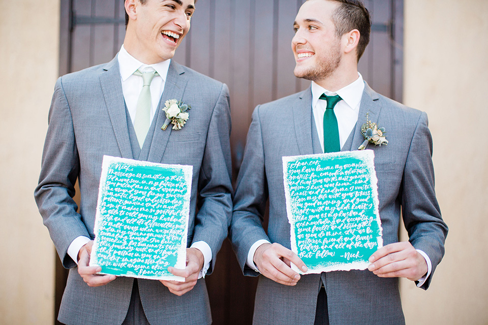 grooms in the same grey suit with 2 different color green ties