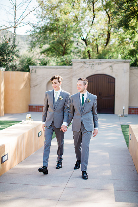  grooms in the same grey suit with 2 different color green ties 