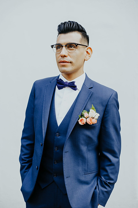  grooms in the same cobalt blue suit with 2 different color ties 