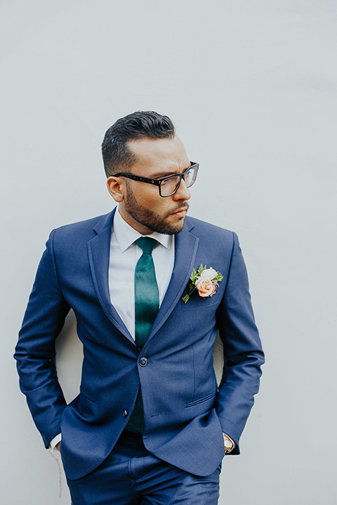  grooms in the same cobalt suit with 2 different color ties 