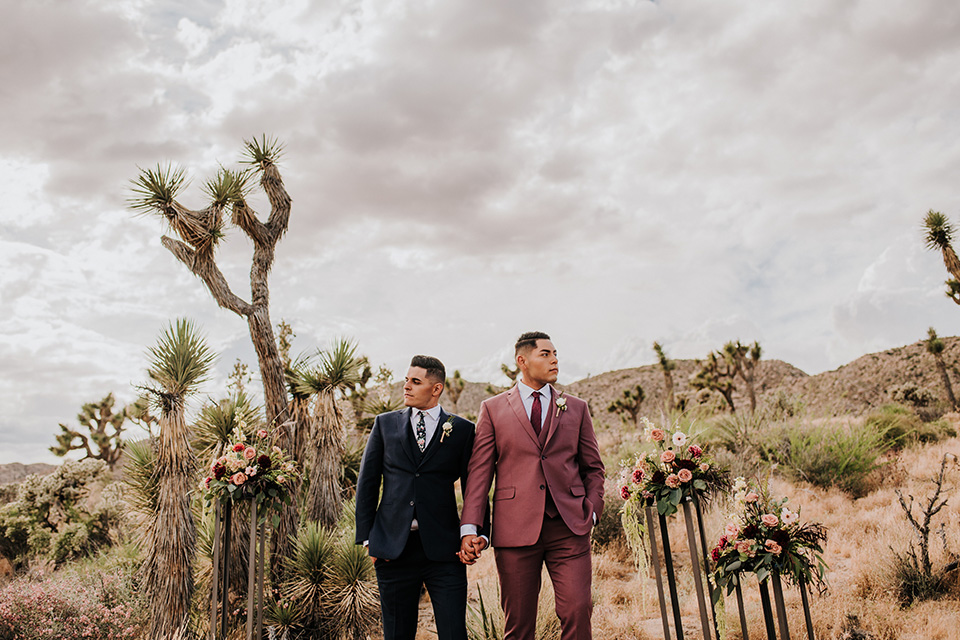 grooms in the same grey suit with 2 different color green ties