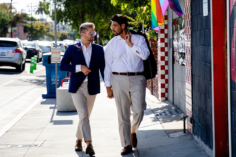 grooms in the same grey suit with 2 different color green ties