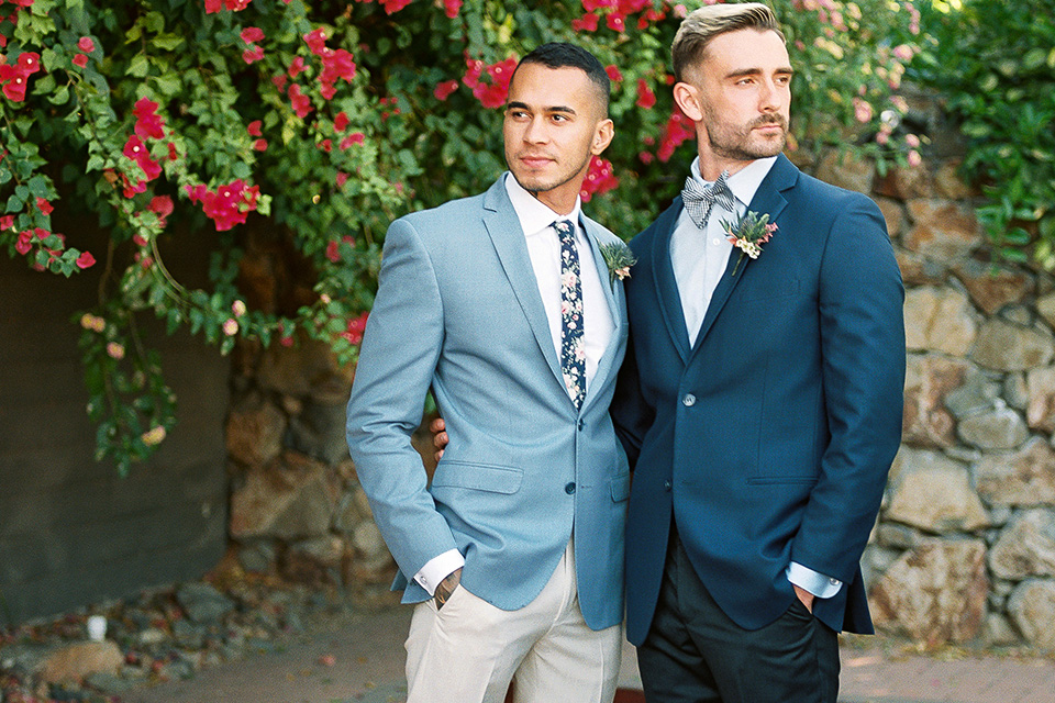 grooms in the same grey suit with 2 different color green ties