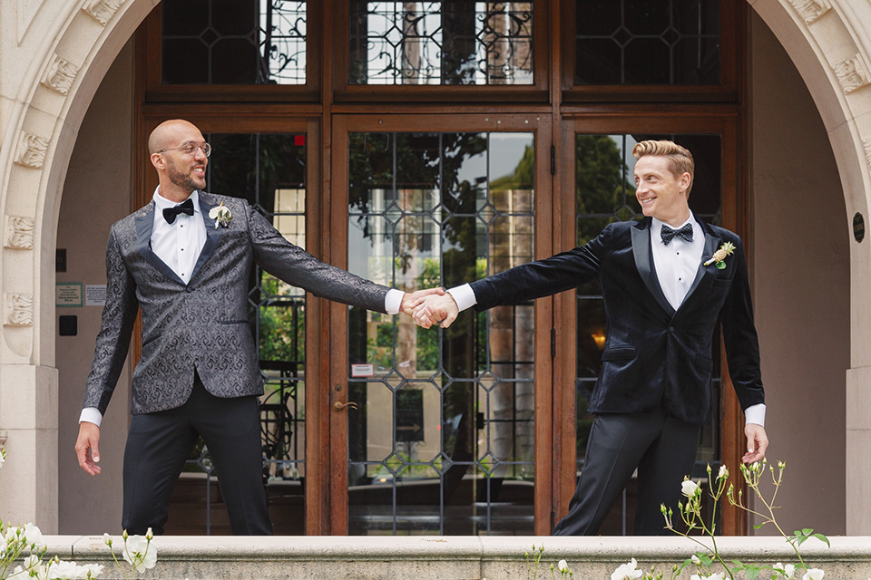 grooms in the same grey suit with 2 different color green ties