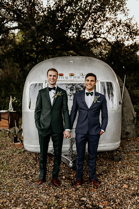  grooms in the same cobalt suit with 2 different color ties 