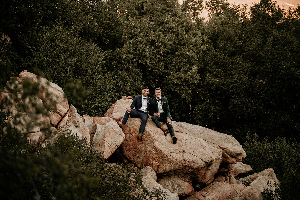 grooms in the same grey suit with 2 different color green ties