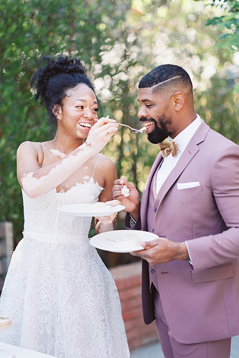  stunning chic pink and yellow wedding very french inspired, bride and groom feeding eachother  