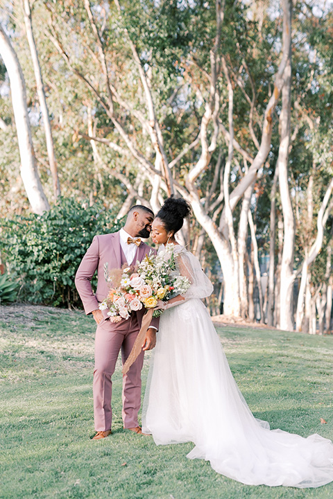  stunning chic pink and yellow wedding very french inspired, bride and groom smiling to camera  