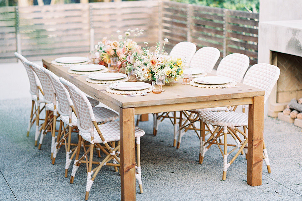  stunning chic pink and yellow wedding very french inspired, the bride is in a soft flowing gown with flutter sleeve and floral appliques and the groom in a rose pink suit with a gold velvet bow tie  