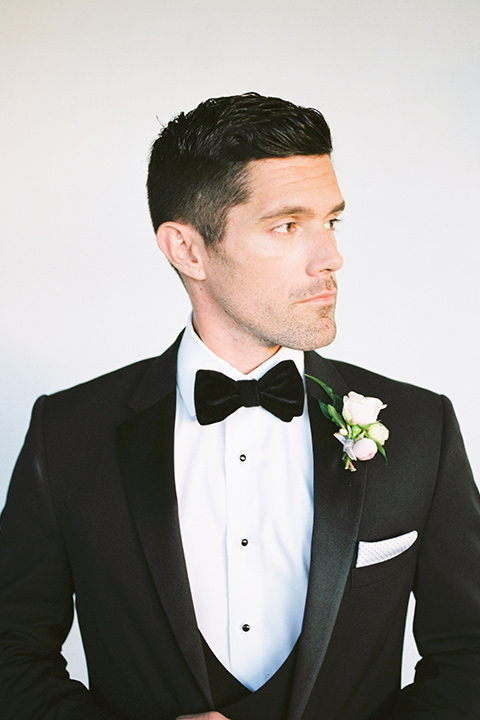  groom wearing a black notch lapel tuxedo 