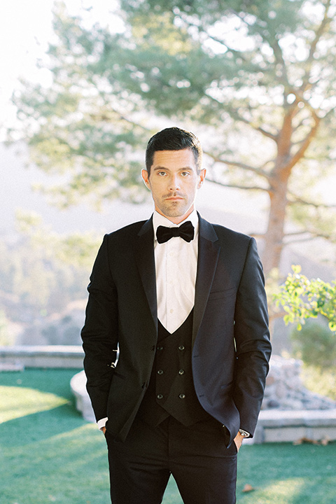  groom wearing a black notch lapel tuxedo 