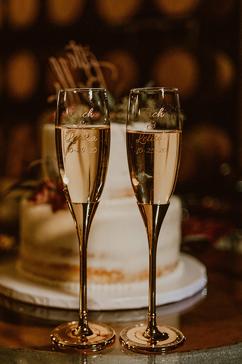  Letitia and Zach’s romantic vineyard burgundy + rose wedding – bride in her lace gown with long sleeves and the groom in a burgundy shawl lapel tuxedo 