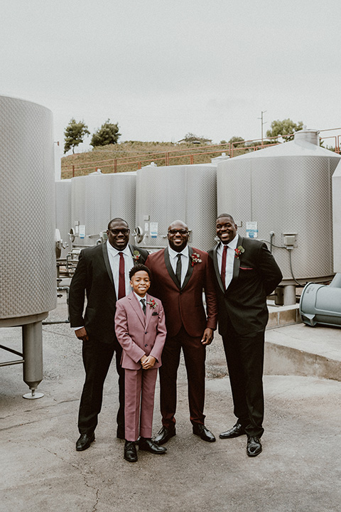  Letitia and Zach’s romantic vineyard burgundy + rose wedding – bride in her lace gown with long sleeves and the groom in a burgundy shawl lapel tuxedo 