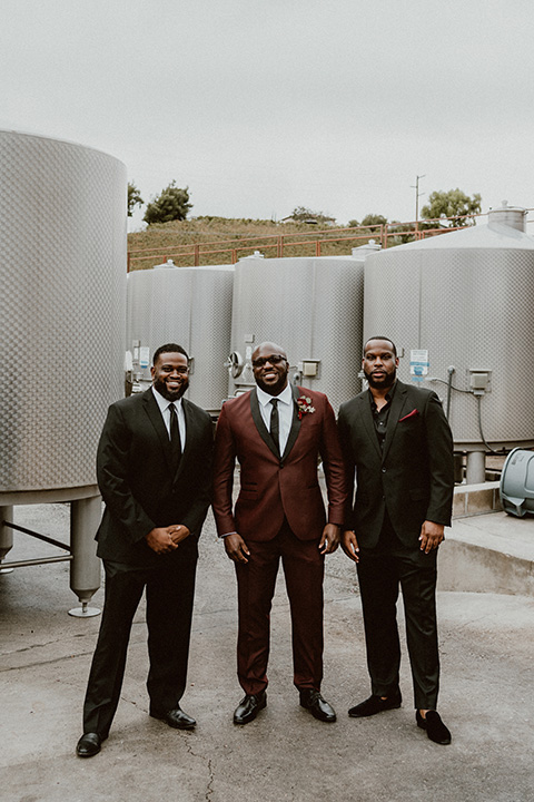  Letitia and Zach’s romantic vineyard burgundy + rose wedding – bride in her lace gown with long sleeves and the groom in a burgundy shawl lapel tuxedo