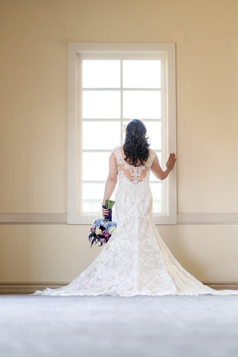  one bride in a white mermaid style gown with a beaded bodice and strapless neckline